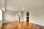 Washington apartment for rent - A room with a wooden floor and white walls.