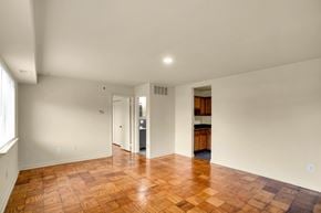 Washington apartment for rent - A room with a wooden floor and white walls.