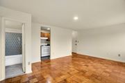 Washington apartment for rent - A kitchen with a white dishwasher and a window with a blue tiled wall.