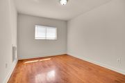 Hyattsville apartment for rent - A room with wooden flooring and a window.