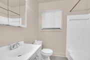 Hyattsville apartment for rent - A white toilet sits next to a sink in a bathroom.