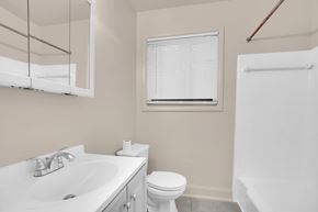 Hyattsville apartment for rent - A white toilet sits next to a sink in a bathroom.