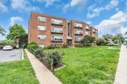 Silver Spring apartment for rent - A red brick apartment building with a green lawn in front.