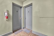 Silver Spring apartment for rent - A hallway with two doors and a fire extinguisher on the wall.