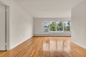 Silver Spring apartment for rent - A room with wooden floors and a large window.