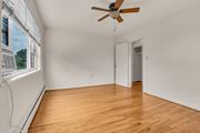 Silver Spring apartment for rent - A room with a ceiling fan and wooden flooring.