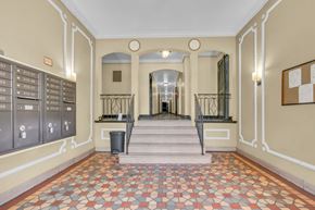 Washington apartment for rent - A hallway with a tiled floor and a series of mailboxes on the wall.