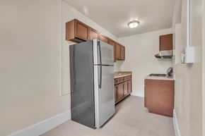 Washington apartment for rent - A kitchen with a refrigerator, sink, and cabinets.
