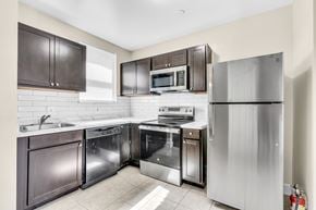 Washington apartment for rent - A kitchen with a stainless steel refrigerator, oven, and dishwasher.