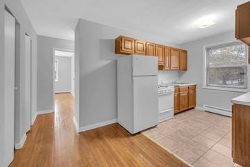 College Park apartment for rent - A kitchen with wooden cabinets and a white refrigerator.