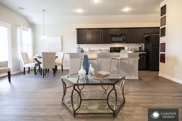 Dallas apartment for rent - A modern kitchen and dining area with a glass table and chairs.