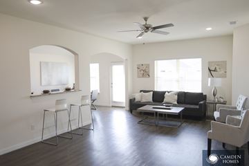 Cleveland apartment for rent - A living room with a black couch and a fan on the ceiling.