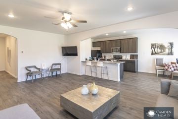 Durant apartment for rent - A living room with a grey sofa and a wooden coffee table.