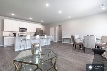 Waxahachie apartment for rent - A modern kitchen with a glass table and chairs in a spacious room.