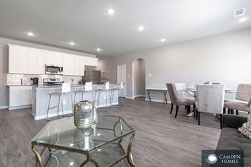 Anna apartment for rent - A modern kitchen with a glass table and chairs.