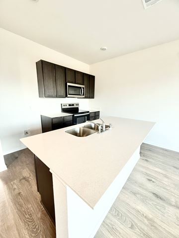Princeton apartment for rent - A kitchen with a white countertop and black cabinets.