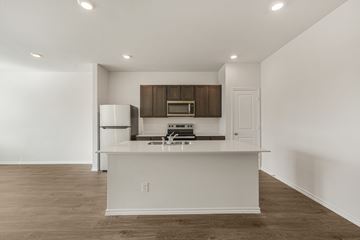 Princeton apartment for rent - A kitchen with white cabinets and a white island.