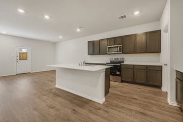 Princeton apartment for rent - A kitchen with brown cabinets and a white countertop.