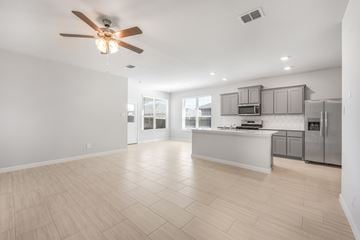 Dallas apartment for rent - A spacious kitchen with a ceiling fan and lighting fixtures.