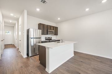 Princeton apartment for rent - A modern kitchen with a white island and stainless steel appliances.