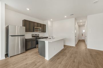 Princeton apartment for rent - A modern kitchen with a white island and stainless steel appliances.