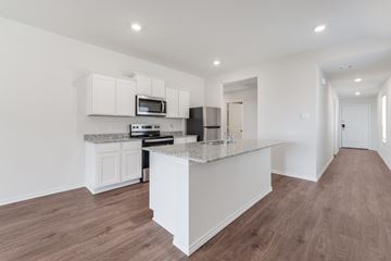 Blue Ridge apartment for rent - A kitchen with white cabinets and a marble countertop.