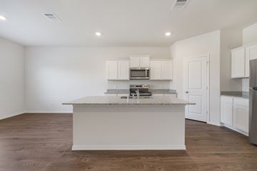 Red Oak apartment for rent - A kitchen with white cabinets and a granite countertop.