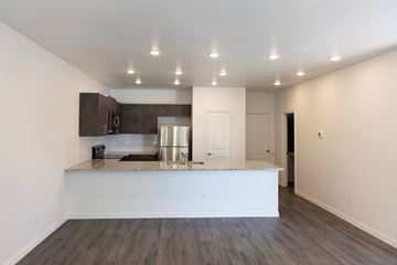 Mesquite apartment for rent - A kitchen with a white counter top and wooden floors.