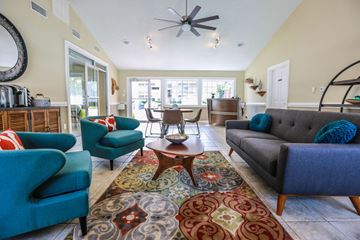 Chesapeake apartment for rent - A living room with a grey couch and a blue chair.