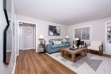 Burien apartment for rent - A living room with a blue couch and a wooden coffee table.