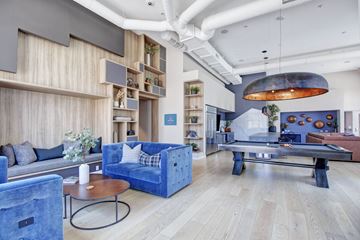 Santa Clarita apartment for rent - A living room with a blue couch and a coffee table.
