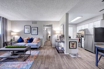 Arvada apartment for rent - A modern living room with a grey couch and a coffee table.