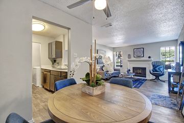 Mesquite apartment for rent - A living room with a wooden table and blue chairs.