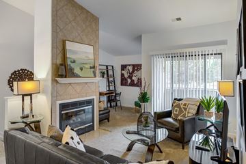 Sterling Heights apartment for rent - A living room with a fireplace and a painting above it.