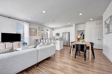 Aubrey apartment for rent - A modern living room with a grey sofa and a wooden dining table.