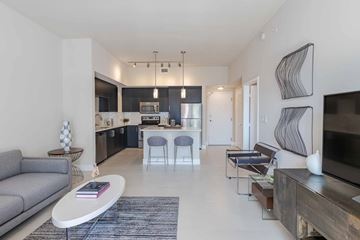 Miami apartment for rent - A modern living room with a grey sofa and a coffee table.