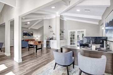 Pomona apartment for rent - A modern living room with a grey sofa and a wooden floor.