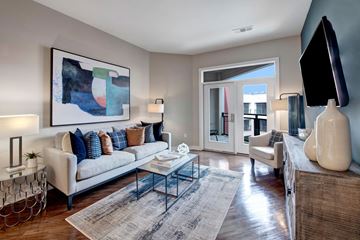 Hyattsville apartment for rent - A living room with a white couch, a coffee table, and a painting on the wall.