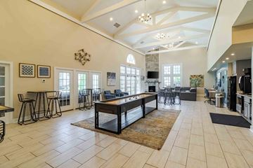 Virginia Beach apartment for rent - A large, well-lit living room with a central coffee table and a bar area.