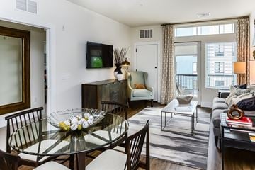 Phoenixville apartment for rent - A modern living room with a glass dining table and chairs.