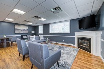 Warwick apartment for rent - A living room with a grey couch and a fireplace.