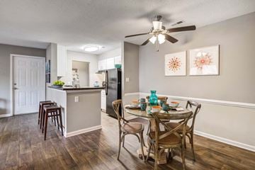Hampton apartment for rent - A kitchen with a table and chairs in the foreground and a refrigerator in the background.
