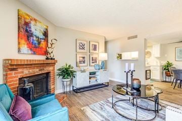 Denver apartment for rent - A living room with a blue couch and a fireplace.