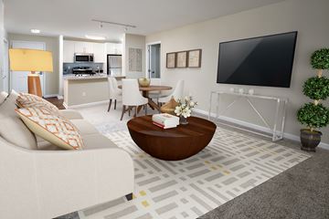 Mamaroneck apartment for rent - A living room with a white couch and a flat screen TV mounted on the wall.