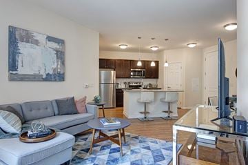 Bala Cynwyd apartment for rent - A modern living room with a grey sofa and a wooden coffee table.