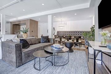 Elmsford apartment for rent - A modern living room with a grey sofa and a coffee table.
