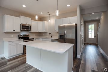 Knoxville apartment for rent - A modern kitchen with white cabinets and a large island.