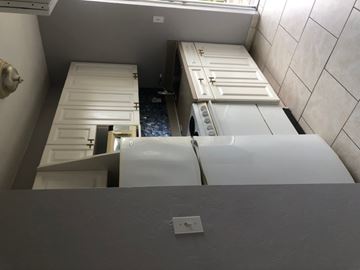 Fort Myers apartment for rent - A white refrigerator is in a kitchen with a white door.