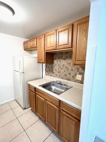 Pompano Beach apartment for rent - A kitchen with wooden cabinets and a white refrigerator.