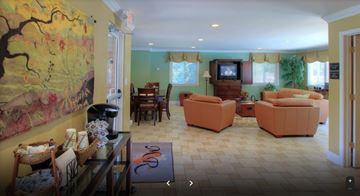 Lynchburg apartment for rent - A living room with a painting on the wall and a television.